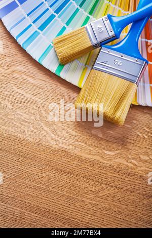 Farbpinsel mit vielen farbigen pantone-Ventilatoren auf Holzplatten Wartungskonzept Stockfoto