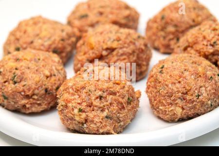 Rohe Fleischbällchen auf weißem Hintergrund Stockfoto