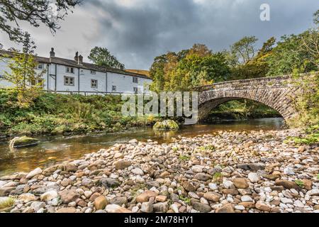 Das George Inn und die Hubberholme Bridge über die River Wharfe, Wharfedale im Yorkshire Dales National Park bei Sonnenschein im Herbst Stockfoto