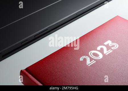 2023 rotes Tagebuch auf einem Schreibtisch. Stockfoto