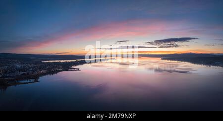 Blick aus der Vogelperspektive auf den westlichen Bodensee vor Sonnenaufgang, mit der Stadt Radolfzell und der Halbinsel Mettnau am Horizont der Insel Stockfoto