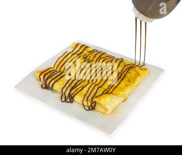 Stanzteil von Sprinkle-Schokolade auf Roti auf weiß isoliert. Stockfoto