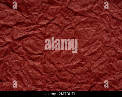 Dunkelrote zerknitterte Papierstruktur. Leeres Seitenmuster für Weihnachtsfestivalkarte im Winter, Neujahrsdesigns Dekoration, Hintergrundkonzepte, Text Stockfoto
