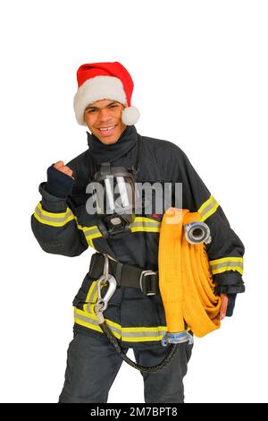 Ein lächelnder Feuerwehrmann, der zu Weihnachten die Faust kneift Stockfoto