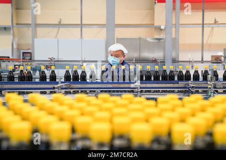 ZHENJIANG, CHIAN - 9. JANUAR 2023 - Arbeiter in einer Werkstatt der Jiangsu Hengshun Group, eines renommierten chinesischen Markenunternehmens, produzieren Saucen und Essig Stockfoto