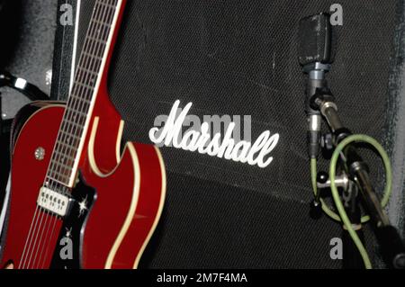 MARSHALL-VERSTÄRKER, ROTE GITARRE, MIKROFON: Ein Detailbild einer roten Gitarre und Marshall-Amp der amerikanischen Band ELECTRIC SIX im Barfly in Cardiff am 2. Februar 2003. Foto: Rob Watkins. INFO: Marshall Amps, ein britisches Unternehmen, ist bekannt für die Herstellung ikonischer Verstärker, die von Generationen von Musikern verwendet werden. Ihr unverkennbarer Sound, ihre Kraft und ihre Langlebigkeit haben sie zu einem Grundpfeiler in der Rock-and-Roll-Geschichte gemacht. Stockfoto