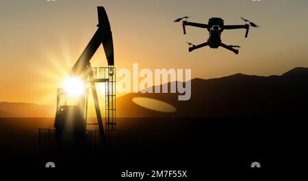 Silhouetten von Drohnen und Bohrinseln Stockfoto