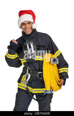 Ein lächelnder Feuerwehrmann, der zu Weihnachten die Faust kneift Stockfoto