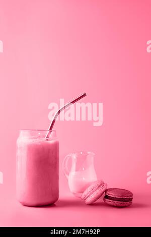 Ein Glas Eiskaffee in einem großen Glas mit Creme und Makronen in trendigen magentafarbenen Farben des Jahres 2023. Speisekonzept. Speicherplatz kopieren. Nahaufnahme. Stockfoto