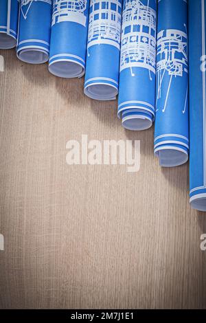 Stapel blauer Blueprint-Rollen auf vertikaler Holzplatte. Stockfoto