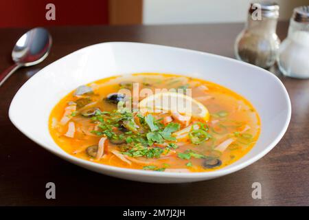 Solyanka ist eine traditionelle russische Suppe, die aus Fleisch, Fisch oder Pilzen und Gemüse wie Tomaten, Zwiebeln, Oliven und Kohl hergestellt wird. Stockfoto