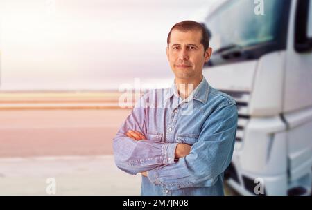 Porträt eines weißen Lastwagens mit gekreuzten Armen, der an seinem Lastwagen stand. Stockfoto