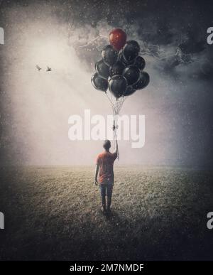 Bizarre Szene eines einsamen Menschen auf dem Feld, der einen Haufen Ballons in der Hand hält, in der Hoffnung zu fliegen. Konzeptionelle und inspirierende Kunst Stockfoto