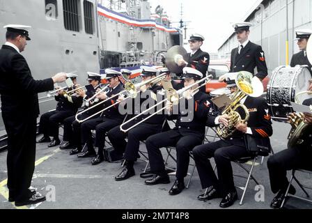 EIN US-AMERIKANISCHER Die Navy Band tritt auf dem Pier neben der geführten Raketenfregatte USS ANTRIM (FFG-20) während der Zeremonie zur Inbetriebnahme des Schiffs auf. Basis: Seattle Staat: Washington (WA) Land: Vereinigte Staaten von Amerika (USA) Stockfoto