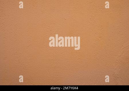 Orangefarbene Betonwandtextur, Nahaufnahme. Stockfoto