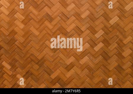 Orange geflochtenes Bambusmuster. Hintergrundstruktur, Nahaufnahme. Stockfoto
