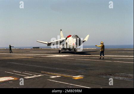 Ein Flugzeugführer gibt dem Piloten eines französischen Kreuzfahrtschiff-Flugzeugs der Marine F-8E (FN) an Bord des nuklearbetriebenen Flugzeugträgers USS DWIGHT D. EISENHOWER (CVN-69) Anweisungen. Land: Mittelmeer (MED) Stockfoto