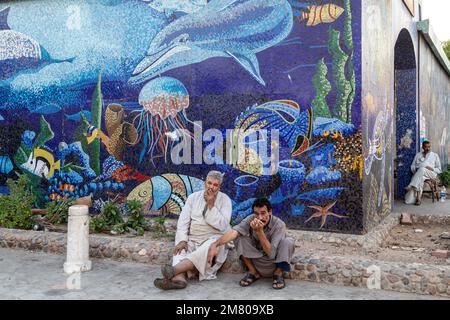 ZIGARETTENPAUSE VOR DEM EINGANG ZUM MOSAIKÜBERDACHTEN SOUK, EL DAHAR MARKT, BELIEBTES VIERTEL IN DER ALTSTADT, HURGHADA, ÄGYPTEN, AFRIKA Stockfoto