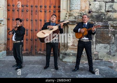 Eine Mariachi-Band in Charro-Kostümen tritt auf den Stufen der Kirche Santo Domingo im historischen Oaxaca, Mexiko, auf. Stockfoto