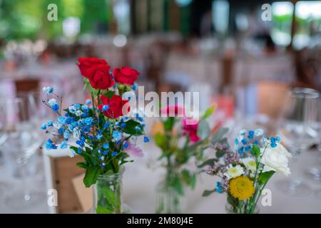 Hochzeitsfoto. Gläser und Blumen auf Tischen. Stockfoto