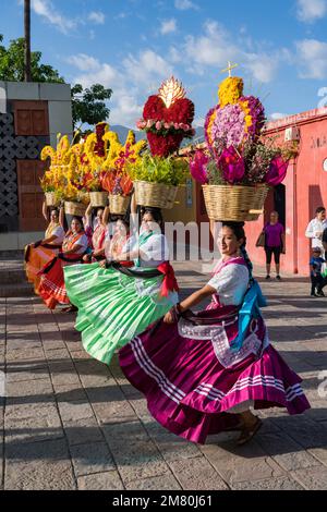 Chinas Oaxaquenas Tänzer mit dekorierten Blumenkörben auf dem Kopf beim Guelaguetza Festival in Oaxaca, Mexiko. Stockfoto