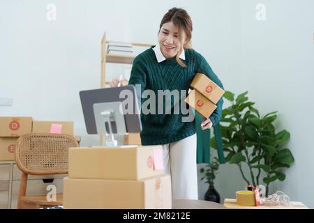 Gründung eines kleinen Unternehmertums für unabhängige asiatische Online-Verkäuferinnen, die Verpackungsprodukte an Kunden versenden, und Lieferkonzept für KMU Stockfoto