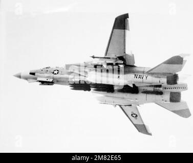 Linke Unteransicht eines F-14 Tomcat-Flugzeugs aus Fighter Sqadron 24 (VF 24) im Flug. Das Flugzeug ist mit einem AIM-7 Sparrow und einem AIM-9 Sidewinder Luft-Luft-Raketen auf dem linken Flügel, EINEM AIM-7 Sparrow Luft-Luft-Raketen auf dem rechten Flügel und mehreren Bomben auf dem Rumpf ausgerüstet. Land: Unbekannt Stockfoto