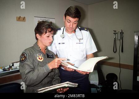HAUPTMANN. (Dr.) Laura Dipuma, Nellis AFB Hospital Squadron und MAJ. (Dr.) Robert A. Pendly, 145. Taktische Klinik, North Carolina Air National Guard, besprechen die Akte eines Patienten. Basis: Luftwaffenstützpunkt Nellis Bundesstaat: Nevada (NV) Land: Vereinigte Staaten von Amerika (USA) Stockfoto