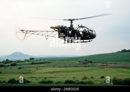 Eine rechte Seitenansicht eines westdeutschen Alouette-III-Hubschraubers, der die ostdeutsche Grenze patrouilliert. Die ostdeutschen Grenzschutzbeamten sind im Hintergrund. Basis: Kassel Land: Bundesrepublik Deutschland (BRD) Stockfoto