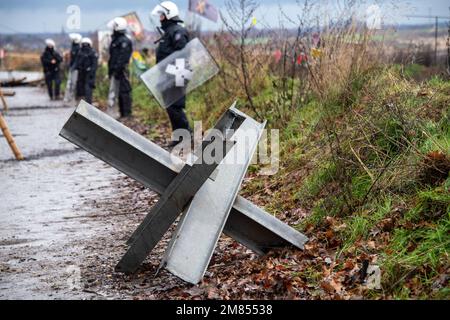 Garzweiler, Deutschland. 11. Januar 2023. Polizisten umzingelten das Protestlager, im Vordergrund eine Barrikade, die Polizei begann heute, die Stadt Luetzerath zu räumen, am 11. Januar 2023, Kredit: dpa/Alamy Live News Stockfoto