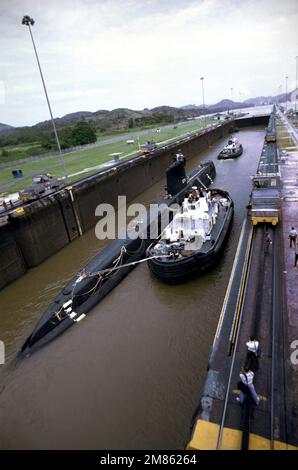 Schlepper begleiten das stillgelegte nuklearbetriebene Angriffs-U-Boot USS NAUTILUS (SSN 571) durch den Panamakanal. Das NAUTILUS ist auf dem Weg von der Westküste zu seinem ursprünglichen Heimathafen an der Naval Submarine Base, New London, Connecticut, wo es als Gedenkstätte in der Submarine Force Library and Museum bleibt. Land: Panama (PAN) Stockfoto