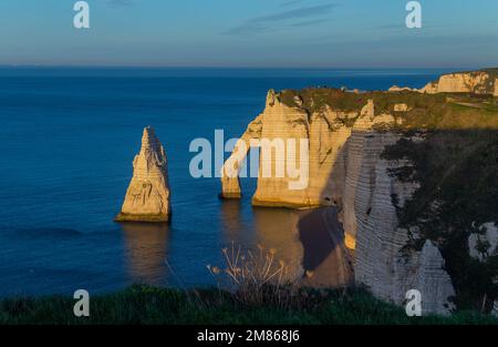 Sonnenuntergang an der Küste in Etretat, Frankreich. Etretat ist eine bezaubernde Stadt, berühmt für die atemberaubenden Klippen von Etretat an der Alabasterküste Stockfoto