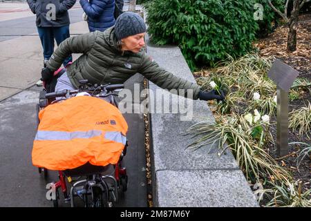 New York, USA. 12. Januar 2023. Marion Van Reeth, Belgien, Der beide Beine verlor, nachdem er während eines Terroranschlags am 31. Oktober 2017 von einem von Sayfullo Saipov bemannten Lkw auf dem Radweg getroffen wurde, legt eine Blume neben einer Gedenktafel zum Gedenken an die Amerikaner Nicholas Cleves und Darren Drake am Ort des Angriffs in Lower Manhattan. Für Saipov könnte die Todesstrafe für den tödlichen LKW-Amoklauf in einem Prozess drohen, der diese Woche vor einem Bundesgericht begann. Kredit: Enrique Shore/Alamy Live News Stockfoto