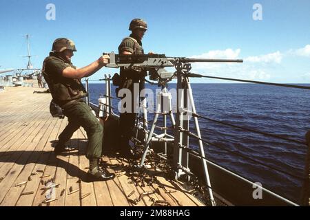 Ein Mitglied der Marine-Einheit an Bord des Schlachtschiff USS MISSOURI (BB-63) zielt während eines Übungsfeuers auf ein M-2 .50-Maschinengewehr. Land: Golf Von Oman Stockfoto