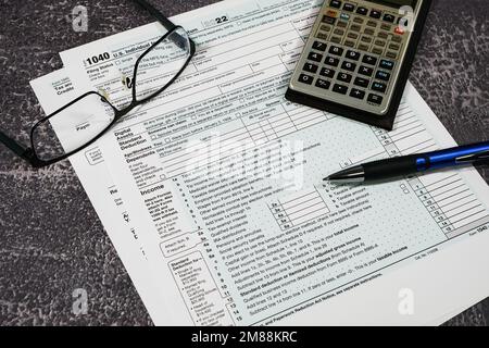 IRS-Formular 1040 mit Taschenrechner und Brille Stockfoto
