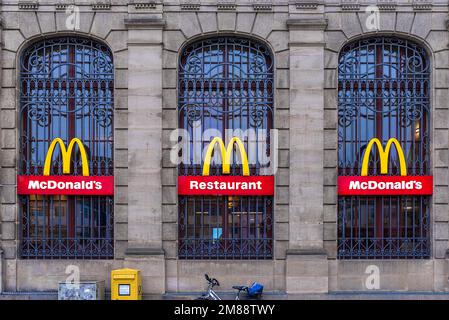 MC-Donald-Logos auf einer denkmalgeschützten Fassade des ehemaligen Hauptpostamts Erlangen, Mittelfrankreich, Bayern Stockfoto