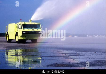 Im Nebel, der von der Wasserkanone auf dem Feuerwehrwagen P-19 der Feuerwehr der Luftwaffe erzeugt wird, bildet sich ein Regenbogen. Basis: Marineflugstation, Jacksonville Bundesstaat: Florida (FL) Land: Vereinigte Staaten von Amerika (USA) Stockfoto