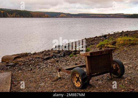 Ein alter, verrosteter Sackkarren, verlassen am See an einem bewölkten Tag Stockfoto