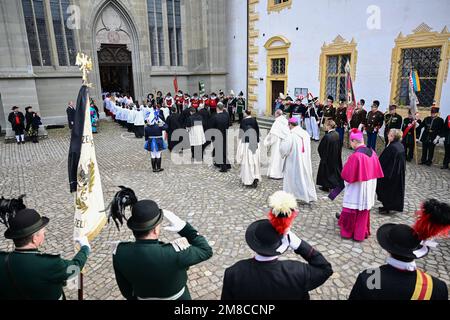 Salem, Deutschland. 13. Januar 2023. Geistliche gehen während der Beerdigung an Gruppen kostümierter Leute vorbei in den Minster. Der Bestattungsservice ist für den Familienkreis, freundliche Häuser und Vertreter aus Politik, Wirtschaft und Kultur. Max Margrave von Baden starb am 29. Dezember im Alter von 89 Jahren im Schloss Salem am Bodensee. Kredit: Bernd Weißbrod/dpa/Alamy Live News Stockfoto