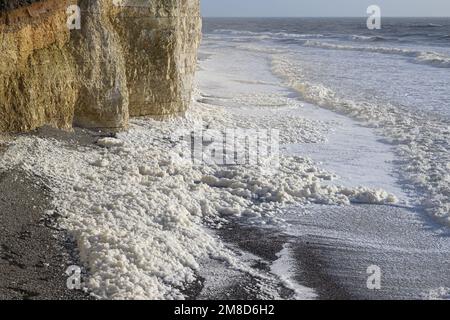 Seeschaum am Strand in Beachy Head, East Sussex, Großbritannien Stockfoto