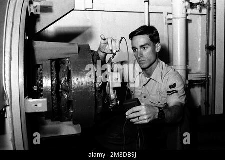Der Elektriker Mate 2. Class Mark Davis, „Sailor of the Year“ für die mittelgroße schwimmende TROCKENLADERAMPE (AFDM-7), verwendet ein Spannungsprüfer zum Prüfen eines Generators. Basis: Marine Air Station, Norfolk Bundesstaat: Virginia (VA) Land: Vereinigte Staaten von Amerika (USA) Stockfoto