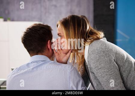 Flüstert Business man ins Ohr. Geheimhaltung Im Amt Stockfoto