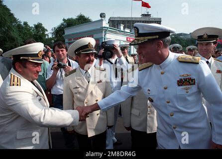 Admiral Charles R. Larson, rechts, Oberbefehlshaber der US-Pazifikflotte, schüttelt einem sowjetischen Kapitän, zweiter Rang, die Hand, nachdem er mit dem geführten Raketenkreuzer USS PRINCETON (CG 59) und der gesteuerten Raketenfregatte USS REUBEN JAMES (FFG 57) in Wladiwostok angekommen ist. Die beiden Schiffe sind nach Wladiwostok gekommen, um einen viertägigen Besuch abzustatten. Basis: Wladiwostok Staat: Sibirien Land: UdSSR (SONNE) Stockfoto