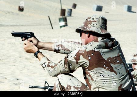 Ein Marine vom 7. Zug, 1. Aufklärungseinheit, feuert seine M-9 9mm-Pistole ab, während er während der Operation Desert Shield am Waffentraining am Abu Hydra Range teilnimmt. Betreff Operation/Serie: WÜSTENSCHILD Land: Saudi-Arabien (Sau) Stockfoto