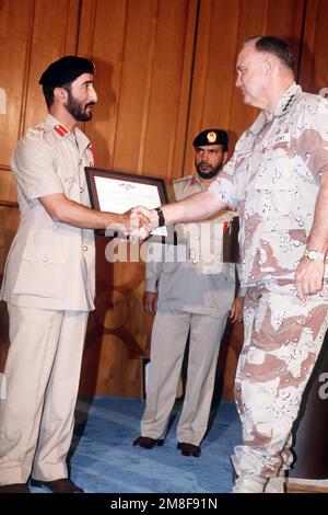 GEN. Norman Schwarzkopf, Oberbefehlshaber, USA Zentralkommando, gratuliere MAJ. GEN. Muhammed sagte Al-Badi, Stabschef der Streitkräfte der Vereinigten Arabischen Emirate, nachdem er ihm die Legion of Merit für seinen Beitrag zu den Koalitionsbemühungen während der Operation Desert Storm übergeben hatte. Betreff Betrieb/Serie: WÜSTENSTURM Land: Katar (QAT) Stockfoto