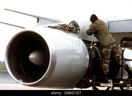 Ein Bodenbesatzungsmitglied arbeitet an einem Triebwerk eines 55. Strategic Reconnaissance Wing RC-135 Stratolifter Flugzeugs, um sich auf eine Ausbildungsmission vorzubereiten. Basis: Offutt Luftwaffenstützpunkt Staat: Nebraska (NE) Land: Vereinigte Staaten von Amerika (USA) Stockfoto