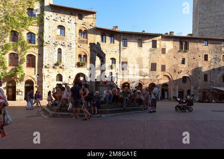 SAN GIMIGNANO, ITALIEN, AM 27. AUGUST 2014. Schnappschuss auf dem Platz am Brunnen. Nicht identifizierte Personen. Editorial use. Stockfoto