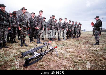 Mitglieder der 554. Staffel für Bauingenieurwesen (Rapid Engineer Deployable, Heavy Operational Repair Squadron, Engineer) stehen in Formation als SENIOR MASTER SGT. Gary Powell übernimmt den Appell am ersten Tag des Einsatzes für die sportlichen Pferdestärken '92. Während der Übung wird das 554.-Personal Straßen reparieren und für ein Marinekorps-Kommando bauen. Zwei 7,62mm M-60 Maschinengewehre sind im Vordergrund abgebildet. Betreff Betrieb/Serie: PFERDESTÄRKEN '92 Basis: D. h. Jima Staat: Okinawa Land: Japan (JPN) Stockfoto