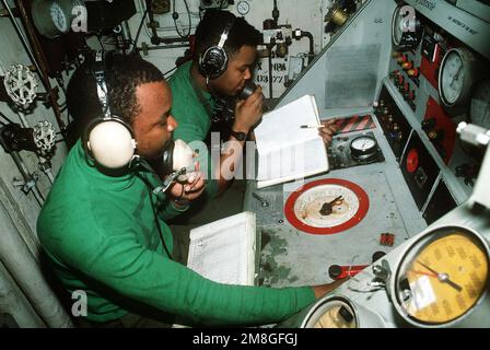 Aviation Boatswain's Mate 1. Class Anthony W. Logan und AIRMAN Harry Settles betreiben die Start- und Bergungsausrüstung im Katapult-Kontrollraum des Flugzeugträgers USS SARATOGA (CV-60) während der Operation Desert Shield. Betreff Operation/Serie: WÜSTENSCHILDBASIS: USS Saratoga(CV 60) Land: Rotes Meer Stockfoto