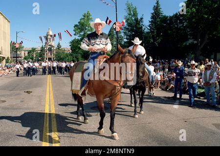 US Air Force General Richard B. Myers, Oberbefehlshaber des nordamerikanischen Luft- und Raumfahrt-Verteidigungskommandos, ist Großmarschall der Cheyenne Frontier Days 103., Cheyenne, Wyoming, reitet am Samstagmorgen auf seinem Pferd, wobei die Air Force Band der Rockies hinter sich her ist. Basis: Cheyenne Staat: Wyoming (WY) Land: Vereinigte Staaten von Amerika (USA) Stockfoto